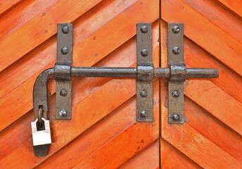 Vintage door lock with padlock on wooden door