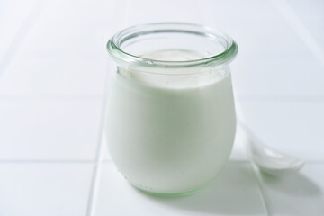 Natural organic yogurt in a vintage glass jar.