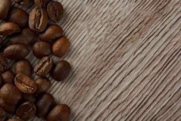 Coffee beans laid out on a background of wood