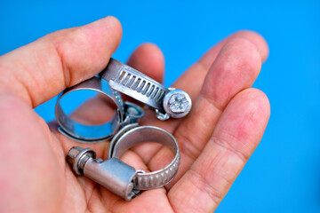 Iron clamps with thread in the hands of the master