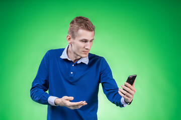 A man closely examines the phone, the application on the phone or the service or tariff offered to him