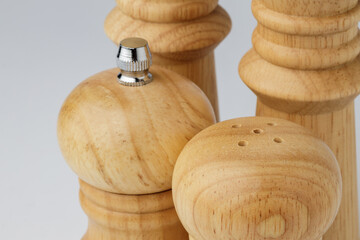 Wooden mills with salt and pepper on white