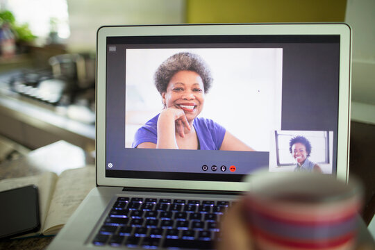 POV women video conferencing on laptop screen
