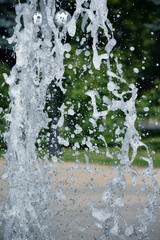 Splashed fountain water in the park. Water drops background