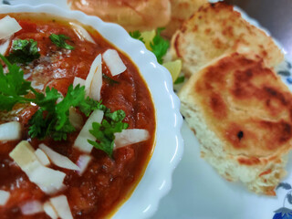 Indian Mumbai food Pav bhaji from vegetables with bread close-up in a bowl on the table. selective focus
