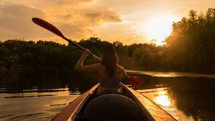 
the girl floats on a kayak on the river.