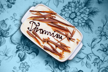 Tiramisu dessert on blue tablecloth
