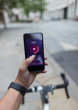 POV Man On Bicycle Using Smart Phone Health App