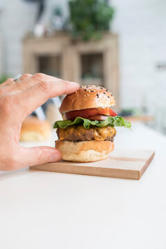 Hand Reaching For Cheeseburger Slider