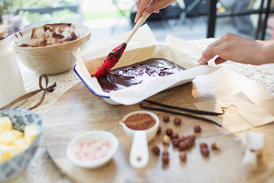 Woman baking chocolate brownies in kitchen
