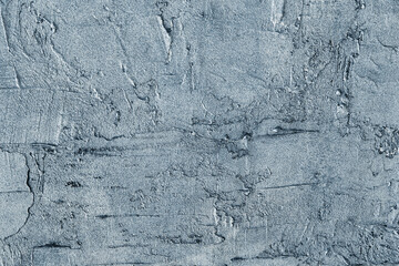 Abstract creative background of chaotic strokes of old cracked paint on concrete wall. Old surface with traces of paint, weathered, scratches and cracks for design