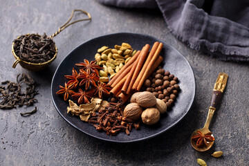 Spices for Indian masala tea. Grey background. Close up.