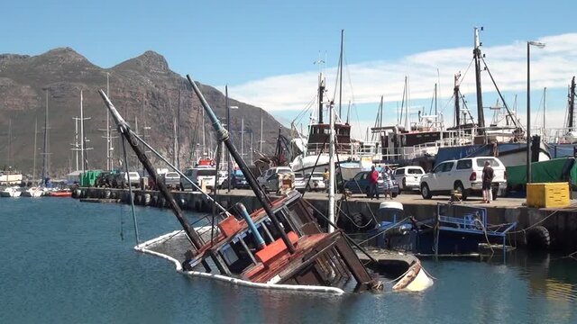 Summer day video of Hout Bay harbour and shipwreck in Cape Town, South Africa