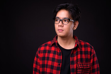 Young handsome Asian hipster man with eyeglasses