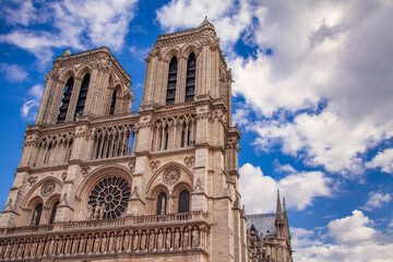 Fototapeta na wymiar Before the epic fire, the twin spires of Notre Dame Cathedral rise into a beautiful blue sky.