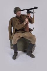 A male actor in the uniform of an officer and a helmet of the Soviet Army during the Second World...