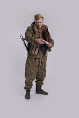 A male actor in the historical uniform of an officer of an army reconnaissance group of the Soviet...