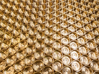 an abstract perspective industrial close-up background of shiny brass metal threaded hexagonal...