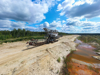 old rusty multi bucket excavator, giant stacker, absetzer in sandy career.