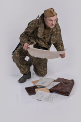 A male actor in the historical uniform of an officer of an army reconnaissance group of the Soviet...