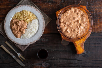 Chicken stroganoff with rice and french fries.