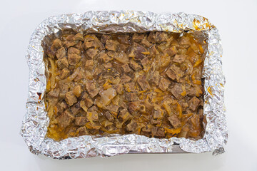 Close up of delicious pieces of meat baking in the oven in the kitchen