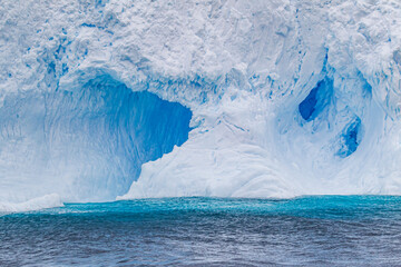 Iceberg with a tunnel floats off the coast of Antarctica