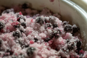 Cooking black currant jam. Berries are covered with sugar in a pan