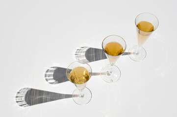 Set of champagne glasses with long sunlight shadow. Still life