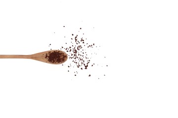 Instant coffee powder in a brown wooden spoon on white isolated background with copy space