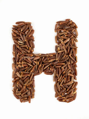 Letter H of the English alphabet made from brown rice on an isolated background.