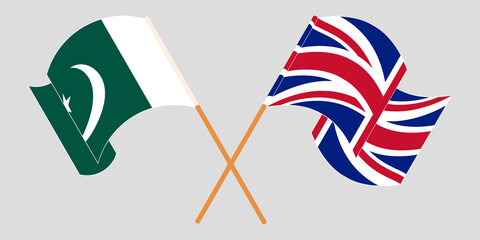 Crossed and waving flags of Pakistan and the UK