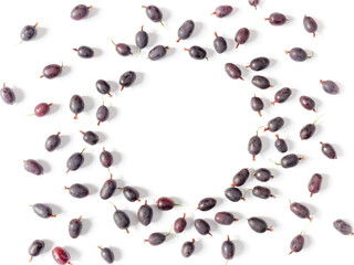 Berry composition. A round frame of fresh black gooseberries is on a white background. Creative berry concept. Flat lay. Top view. Copy space.
