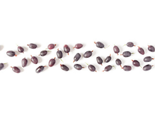 Fresh berries of black gooseberries are on a white background. Creative berry concept. Flat lay. Top view.