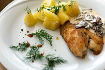 Baked fish with mushrooms and eggplants. Cream sauce with dill