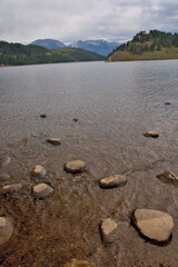 Mountain Landscape in the background of a rock lined lake