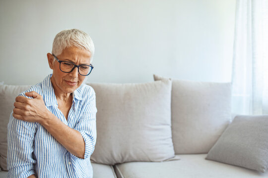 Senior woman with shoulder pain. Elderly woman is enduring awful ache. Neck and shoulder pain, old woman suffering from neck and shoulder injury, health problem concept