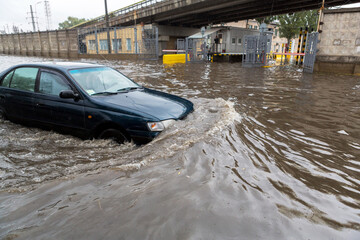 Odessa, Ukraine - September 20, 2016: Driving cars on a flooded road during flooding caused by...