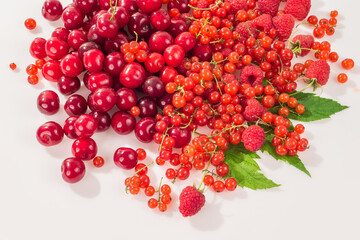 Assorted berry on a white background. Cherries, raspberries, red currants.