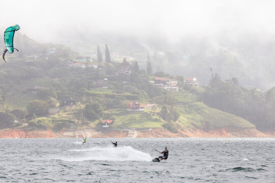 young man kiteboarding at lake calima, colombia