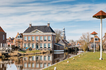 Fototapeta na wymiar Residential buildings, canal and footbridge in Hindeloopen, Friesland, Netherlands, Europe