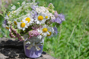 a bouquet of wild flowers on a natural background of greenery