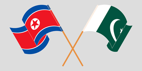 Crossed and waving flags of Pakistan and North Korea