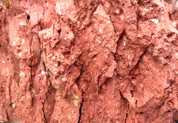 The texture of a reddish brick.