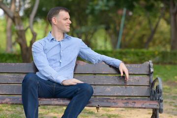 Fototapeta premium Portrait of happy businessman relaxing at the park