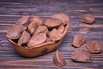 Paranuts in an olive wood cup, vegetarian food in wooden bowls