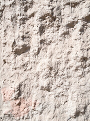 rough plastered outdoor wall lit by sun in sunny day