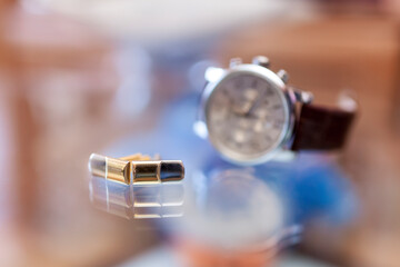 Cufflinks and wristwatch