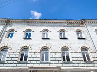 facade of old brick urban house in Borisoglebsky lane in Moscow (former building of Alexander's shelter for terminally ill and crippled committee of Christian Aid of Red Cross Society, built in 1882)