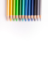 A set of colored pencils lined up on top of the vertical photograph. On a white background